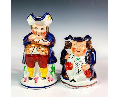 Ceramic figural jugs hand painted wearing a blue jacket holding a pot of snuff. Allertons backstamp. Largest measures: 4"L x 