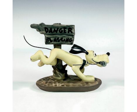 Porcelain figure with matte finish. Depicts Pluto racing pass a "Danger Blasting" sign with a stick of dynamite in his mouth.