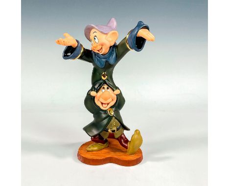 Porcelain figure with matte and gilded finish. From the 1937 animated film, Snow White, depicts Dopey and Sneezy dancing. Wal
