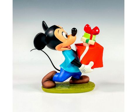Porcelain figure with matte finish. 1995 Holiday Annual figure depicting Mickey Mouse holding gifts. Inspired from the 1952 a