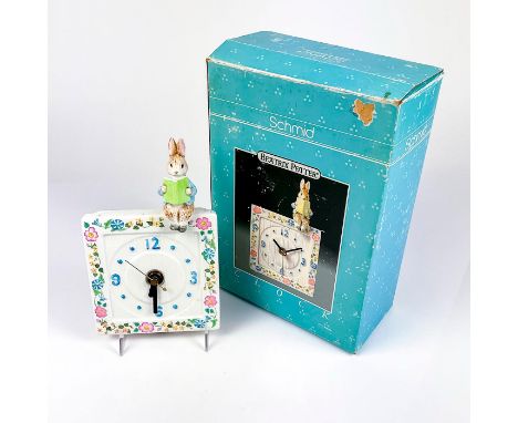 Porcelain clock with floral pattern and Peter rabbit sitting, reading a book in glossy finish. Factory backstamp.This item ha