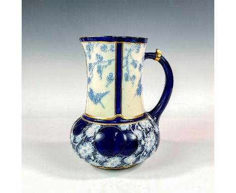 A porcelain handled pitcher embossed with blue birds and flowers against an ivory and cobalt blue ground. Gold gilt decoratio