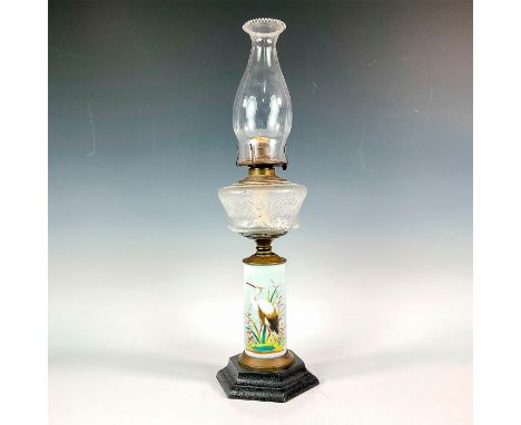 A tall oil lamp with glass lamp chimney and burner, bronze shade holder and octagonal black base. The oil font is hand painte