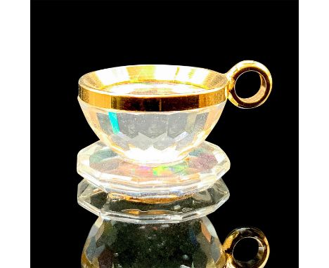 A clear faceted teacup with gold metal accent. This item has its original box: 3.5"L x 2.25"W x 1.25"H. Artist: Anton Popping