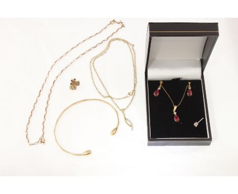 POLICE > A 9ct torque style bangle, two 9ct chains & stone set pendant, a pair of 9ct studs, a ruby set pendant & earring set