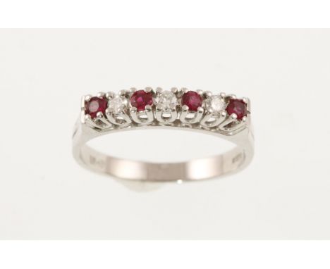 An 18ct H/M white gold seven stone ruby and diamond ring, the diamonds totalling approx 0.25ct, approx 3.8gms, size Q