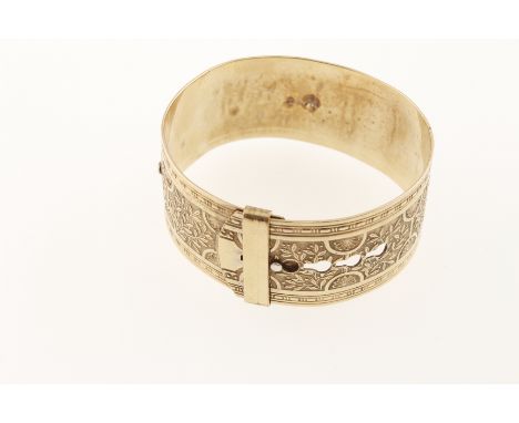 A gold plated bangle with embossed floral decoration and buckle style clasp, marked 9ct & silver, approx 1930
