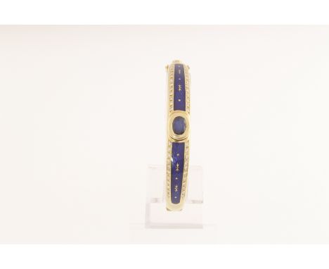 A modern FABERGE 18ct bangle (stamped 750) set with a cebtral oval sapphire, two rows of diamonds & blue enamel, also marked 