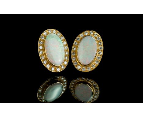 18ct Gold Superb Quality and Impressive Pair of Opal and Diamond Set Earrings. Marked 18ct - 750. The Large Oval Shaped Opals