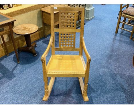 Workshop of Robert Mouseman Thompson of Kilburn (British, 1876-1955) An English Oak Rocking Chair, with two lattice panel bac