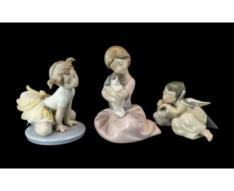 Three Lladro Figures, comprising No. 5728 'Heavenly Dreamer', a small angel sleeping, No. 1451, 'My Puppy Love', and No. 1699