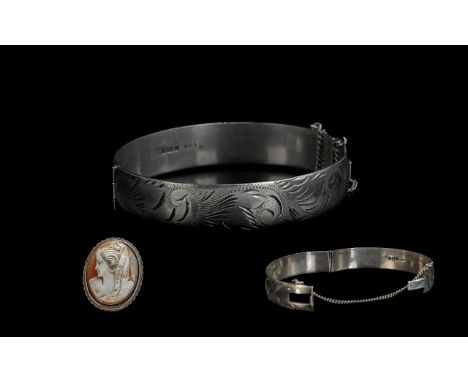 A Hinged Silver Bangle, together with a silver framed shell cameo.