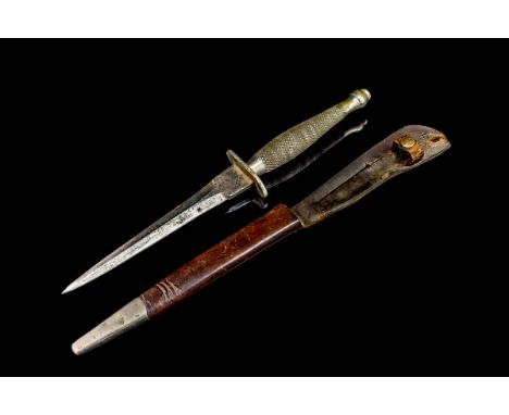 A Rare Fairbairn Sykes 1st Pattern Fighting Knife, by Wilkinson Sword, with 16cm blade, in metal mounted leather sheath.