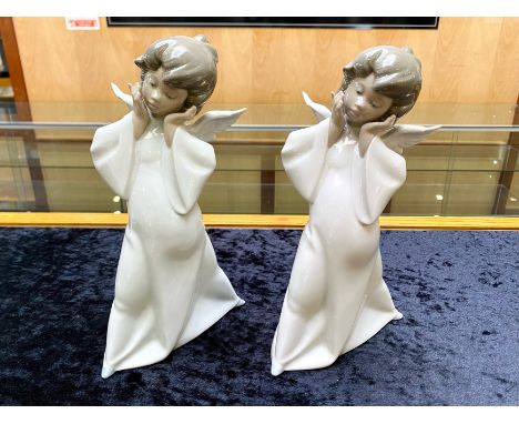 Two Lladro Angels, measuring approx. 9'' tall, 'Curious Angels'.  In excellent condition.  HN 4960.