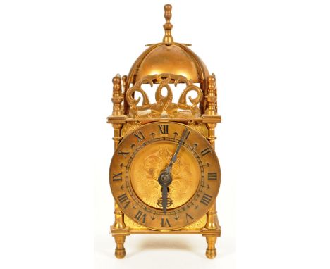 Smiths, England - A vintage mid 20th century brass lantern clock. Having a domed top with Roman numeral chapter ring and ebon