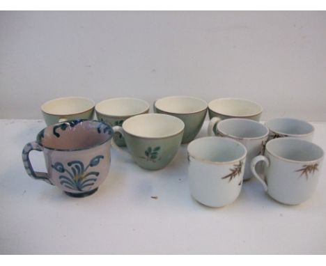 A quantity of coffee cups to include Poole Pottery and four hand painted with chrome bamboo designs. (10)