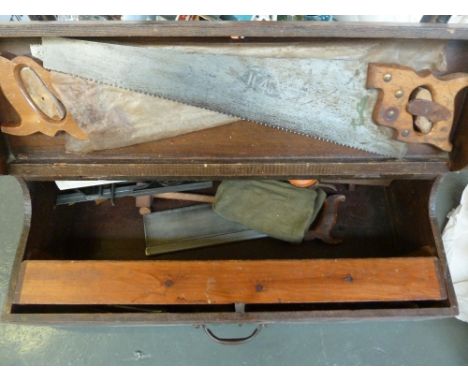 A vintage tool trunk, the side opening to reveal store for saws, planes, other tools