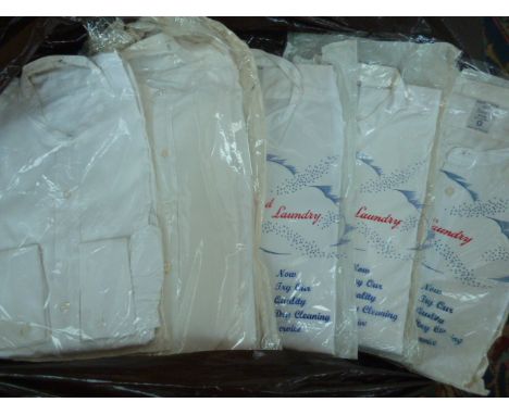 A bag of vintage white collarless shirts.