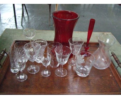 A quantity of glassware to include a red glass vase and poesy vase, a twist stem sherry glass, various port glasses, a Royal 