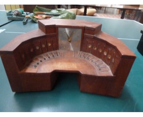 A mahogany cased mantle clock in the form of a control panel, square metal dial with brass numerals