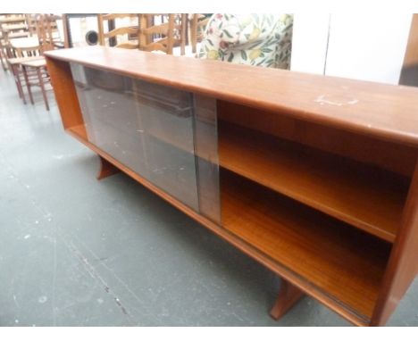 A 1960's Scandinavian style teak sideboard, two glazed sliding doors above bracket feet, 180cmW