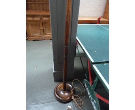 An oak standard lamp, turned stem and base