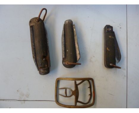 Three vintage folding knives and tools, with a vintage brass buckle