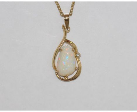 14ct gold and good colour solid opal set with diamond in surround, on gilt metal chain
