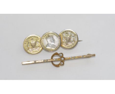 Two vintage brooches comprising a silver coin brooch and a metal ring/bar brooch
