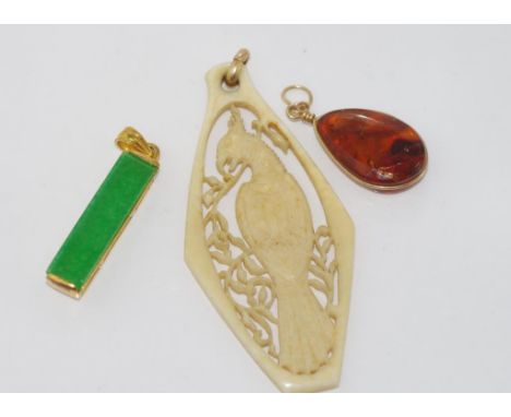 Vintage carved ivory bird pendant with two other pendants