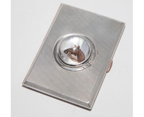 Rectangular hallmarked silver engine turned cigarette case with Essex crystal depicting a racehorse applied to the lid 