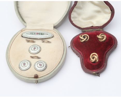 2 cased sets of shirt studs, one as a gold celtic knot, the other with enamel and floral decoration 