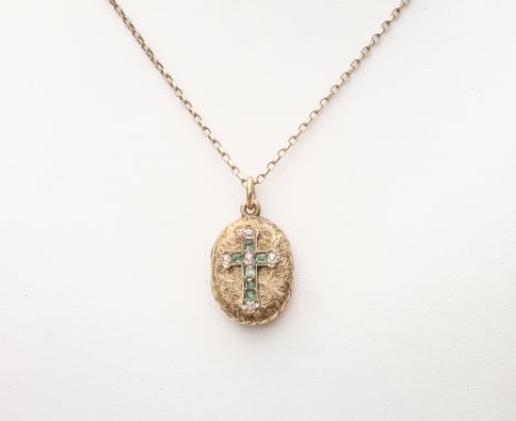 Small Victorian oval gold locket with engine turned floral design and decorated with emerald and diamond cross on a 9ct gold 