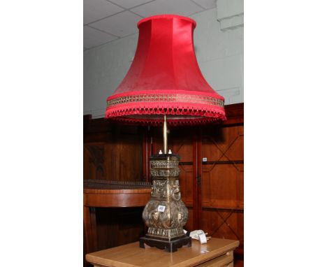 Oriental brass table lamp with red shade 