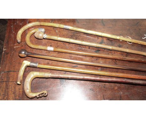 Group of 6 vintage walking sticks to include carved horn handle and 3 silver mounted examples 