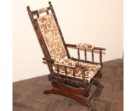 American walnut framed rocking elbow chair with tapestry upholstered seat and back 