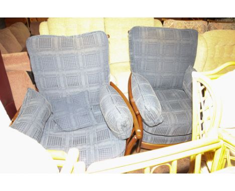 Pair of Ercol dark framed easy chairs with blue patterned loose cushions 