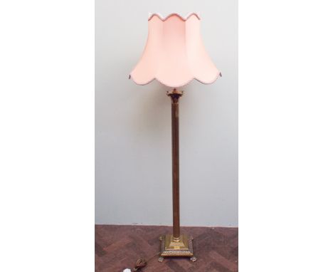 Heavy corinthium column brass standard lamp with shade standing on four paw feet 