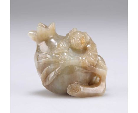 A CHINESE JADE POMEGRANATE CARVING with a figure clinging to a stalk. 4cm high