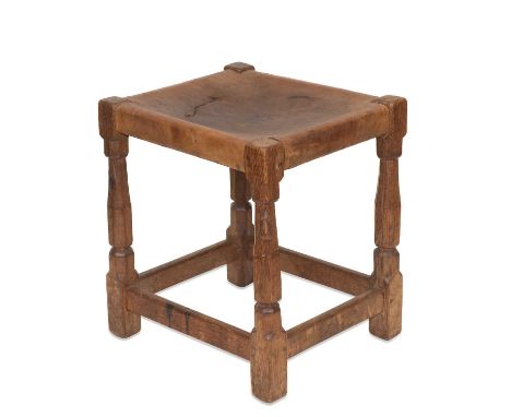 ROBERT THOMPSON OF KILBURN, AN EARLY MOUSEMAN OAK STOOL, CIRCA 1930S the leather seat raised on faceted baluster legs continu