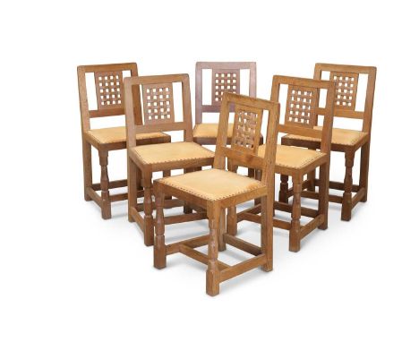 ROBERT THOMPSON OF KILBURN, A SET OF SIX MOUSEMAN OAK DINING CHAIRS each with lattice back and faceted baluster legs continui