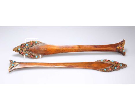 A PAIR OF TIBETAN 'FLAMING' BRONZE SWORDS each 'jewelled'. (2) 40cm longSome 'jewels' re-applied, in otherwise good condition