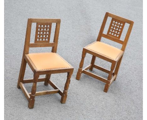 ROBERT THOMPSON OF KILBURN, A PAIR OF MOUSEMAN OAK SIDE CHAIRS with lattice backs, each with carved mouse signature. (2) Heig