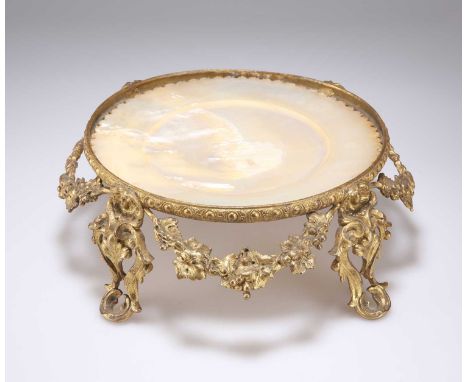 A 19TH CENTURY GILT BRONZE AND MOTHER-OF-PEARL CENTREPIECE circular, with swags of grapevine and scroll-cast feet. 25cm diame