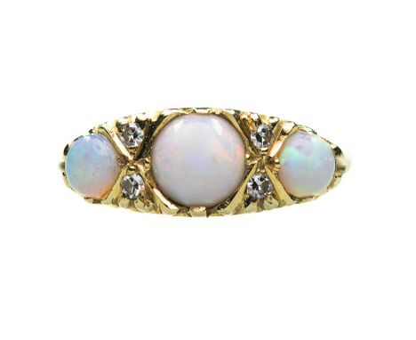 AN 18 CARAT GOLD OPAL AND DIAMOND RING three graduated round opals spaced by eight-cut diamond accents, to a carved setting. 