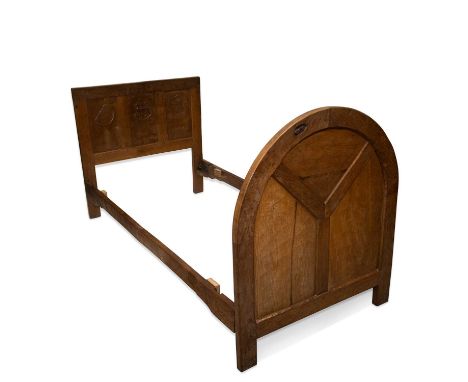 ROBERT THOMPSON OF KILBURN, AN EARLY MOUSEMAN OAK SINGLE BED, CIRCA 1930S the three-panel headboard carved with three roundel