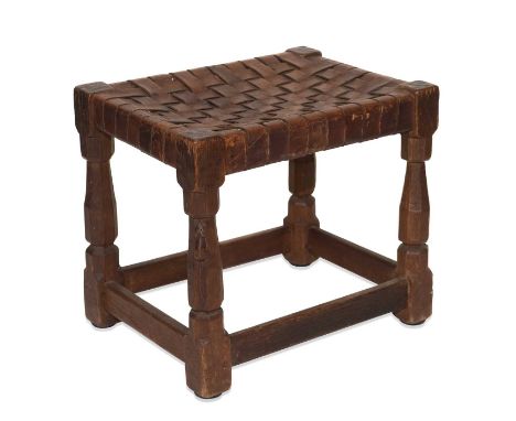 ROBERT THOMPSON OF KILBURN, AN EARLY MOUSEMAN OAK AND LEATHER STOOL, CIRCA 1930S the rectangular leather lattice-work seat ra