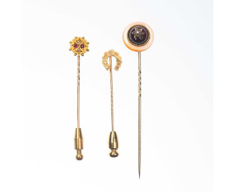 THREE STICKPINS comprising an agate, garnet and seed pearl stickpin, unmarked, 1.5cm diameter; a ruby and diamond stickpin, m