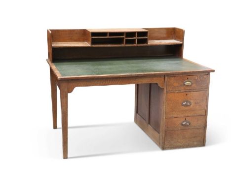 A VINTAGE "MINISTRY" OAK DESK the inset writing surface with shelf back, above one three-drawer pedestal. 107.5cm high, 141.5