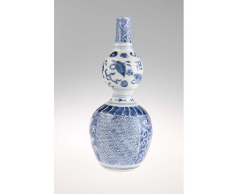 A CHINESE BLUE AND WHITE PORCELAIN DOUBLE GOURD VASE, PROBABLY KANGXI/QIANLONG decorated with auspicious symbols and varying 